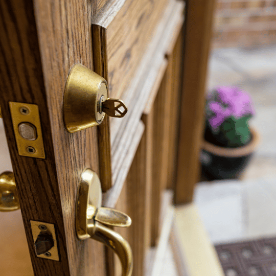 Open Front door with key in lock after gaining entry to house. Residential Locksmith - San Antonio, TX - The Key Man Locksmith